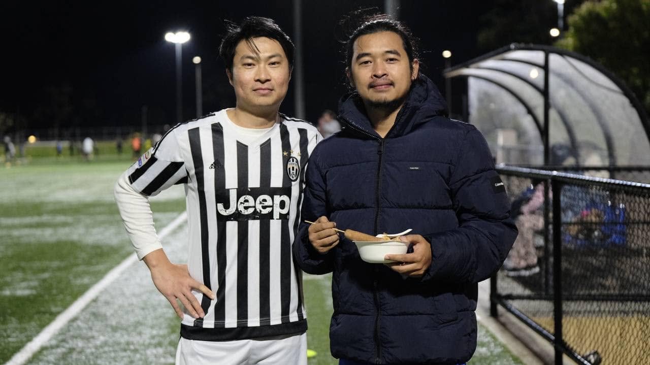 Two players side by side, one in a Juventus shirt and one in a navy puffer